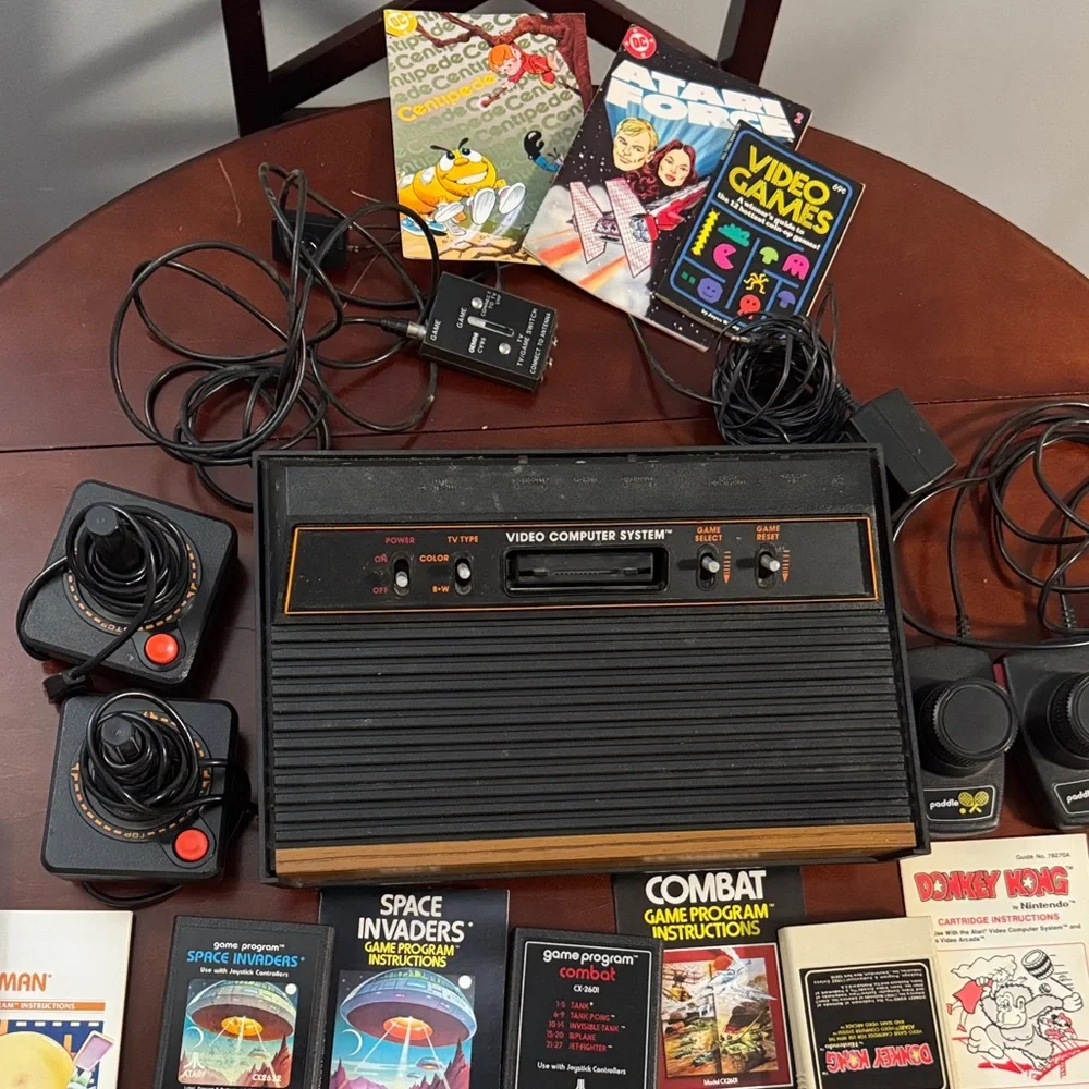 Vintage Authentic Atari 2600 with controllers, games and instruction booklets.